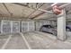 Well lit parking garage featuring car, metal storage units, and concrete walls at 5677 S Park Pl # B110, Greenwood Village, CO 80111