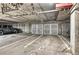 Spacious parking garage featuring car, SUVs and metal storage units at 5677 S Park Pl # B110, Greenwood Village, CO 80111