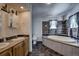 Bathroom with wood accents featuring soaking tub, shower, and double sinks at 492 Kimmes Ln, Breckenridge, CO 80424