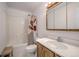 Bright bathroom featuring a sink vanity with a mirror, toilet and shower with tub and curtain at 492 Kimmes Ln, Breckenridge, CO 80424