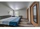 Spacious bedroom with wood-look flooring, large windows, and closet with mirror at 492 Kimmes Ln, Breckenridge, CO 80424