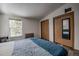 Bright bedroom featuring wood-look flooring, large window and a closet with mirrored door at 492 Kimmes Ln, Breckenridge, CO 80424