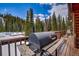 Deck with a grill and wooded view, ideal for outdoor cooking and relaxation at 492 Kimmes Ln, Breckenridge, CO 80424