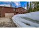 Log cabin with attached garage, upper deck, and winter landscape at 492 Kimmes Ln, Breckenridge, CO 80424