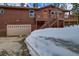 Log cabin with attached garage, upper deck, and winter landscape at 492 Kimmes Ln, Breckenridge, CO 80424