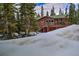 Beautiful log cabin home nestled among evergreens and covered in snow at 492 Kimmes Ln, Breckenridge, CO 80424