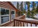 Inviting log cabin with a cozy deck and views of the surrounding snow-covered landscape at 492 Kimmes Ln, Breckenridge, CO 80424