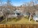Aerial view of the home's backyard with a well-kept lawn, patio, deck, and fencing at 6252 W 70Th Pl, Arvada, CO 80003