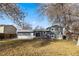Backyard view showcasing the home's siding, elevated deck, and landscaped yard at 6252 W 70Th Pl, Arvada, CO 80003