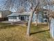 View of the backyard with a raised deck, mature trees and a well-maintained lawn at 6252 W 70Th Pl, Arvada, CO 80003