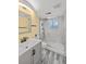 Updated bathroom featuring a vanity, a modern mirror, and a shower with marble surround at 6252 W 70Th Pl, Arvada, CO 80003