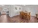 A dining room with hardwood floors featuring a wooden dining table with 6 chairs at 6252 W 70Th Pl, Arvada, CO 80003
