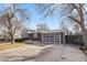 Exterior view of the home featuring a 2-car garage with a light colored door, and brick accents at 6252 W 70Th Pl, Arvada, CO 80003