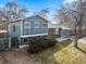 Charming two-story home boasts a blue exterior, brick accents, and a well-maintained front yard at 6252 W 70Th Pl, Arvada, CO 80003