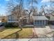 Charming home featuring brick accents, mature trees, and an attached garage at 6252 W 70Th Pl, Arvada, CO 80003