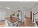 Bright kitchen featuring stainless steel appliances, a kitchen island, and hardwood floors at 6252 W 70Th Pl, Arvada, CO 80003
