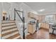 Traditional kitchen with stainless steel appliances, wood floors, and a staircase to the left at 6252 W 70Th Pl, Arvada, CO 80003