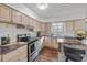 Modern kitchen with stainless steel appliances and a kitchen island with stylish chairs at 6252 W 70Th Pl, Arvada, CO 80003