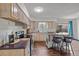 Updated kitchen features stainless steel appliances, a kitchen island with chairs, and light wood cabinets at 6252 W 70Th Pl, Arvada, CO 80003