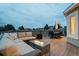 Inviting outdoor back deck with comfortable seating, fire pit, and picturesque views at 19185 Breton Pl, Monument, CO 80132