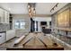 Basement featuring a pool table, a bar with white cabinetry and a living space with cozy seating and fireplace at 19185 Breton Pl, Monument, CO 80132