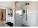 Bright bathroom featuring a glass enclosed shower, double vanity, and decorative tile flooring at 19185 Breton Pl, Monument, CO 80132