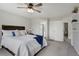 Cozy bedroom featuring a ceiling fan, view to the bathroom, and well-lit hallway at 19185 Breton Pl, Monument, CO 80132