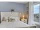 Close-up of a bedroom featuring a plush bed with decorative pillows, neutral color scheme and a scenic window view at 19185 Breton Pl, Monument, CO 80132