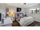 Bedroom with hardwood floors, stylish decor, and a bright window, creating a comfortable and inviting space at 19185 Breton Pl, Monument, CO 80132