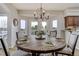 Bright dining area features a rustic table, modern lighting, and sliding doors to the outdoors at 19185 Breton Pl, Monument, CO 80132