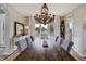 Stylish dining room with a rustic wood table, elegant chandelier, and views of the surrounding greenery at 19185 Breton Pl, Monument, CO 80132