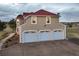Three-car garage with red roof and ample parking space at 19185 Breton Pl, Monument, CO 80132