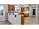 Kitchen features warm wood cabinets, granite counters, and a breakfast bar at 19185 Breton Pl, Monument, CO 80132