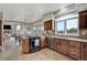 Gourmet kitchen offers stainless steel appliances, granite countertops, and hardwood floors throughout at 19185 Breton Pl, Monument, CO 80132