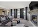 Basement living room featuring a fireplace, comfortable leather seating, large windows and an open floorplan at 19185 Breton Pl, Monument, CO 80132