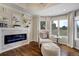 Cozy living room features a modern fireplace, ample natural light, and comfortable seating at 19185 Breton Pl, Monument, CO 80132
