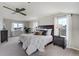 Bright main bedroom featuring a ceiling fan, plush carpets, and large windows with stunning views at 19185 Breton Pl, Monument, CO 80132