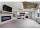 Spacious main bedroom with a modern fireplace, TV, elegant ceiling, and plush carpets at 19185 Breton Pl, Monument, CO 80132