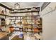 Walk-in pantry with custom shelving provides ample storage for all your kitchen essentials at 19185 Breton Pl, Monument, CO 80132