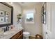 Stylish powder room features a granite countertop and decorative accents for added charm at 19185 Breton Pl, Monument, CO 80132