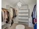 Well-organized walk-in closet with ample shelving, hanging space, and a decorative chandelier at 19185 Breton Pl, Monument, CO 80132
