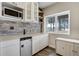 A wet bar with mini-refrigerator, stone backsplash, and bright natural light from the window at 19185 Breton Pl, Monument, CO 80132