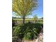 Serene backyard featuring manicured lawn, mature trees, and views of the green golf course at 653 Glenarbor Cir, Longmont, CO 80504