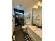 Modern bathroom with glass-enclosed shower, sleek sink, and decorative 'Relax and Unwind' sign at 653 Glenarbor Cir, Longmont, CO 80504