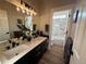 Bathroom with double sinks, a large mirror, and a tiled shower and bath at 653 Glenarbor Cir, Longmont, CO 80504