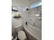 Bathroom featuring a shower over the tub with tile surround and black fixtures at 653 Glenarbor Cir, Longmont, CO 80504