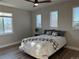 Bright bedroom features a ceiling fan, three windows, wood floors, and a neutral color scheme at 653 Glenarbor Cir, Longmont, CO 80504
