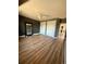 Bedroom with gray accent wall, a ceiling fan, sliding closet doors, and wood floors at 653 Glenarbor Cir, Longmont, CO 80504