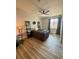 Nicely decorated bedroom featuring a ceiling fan, a window, wood floors, and plants at 653 Glenarbor Cir, Longmont, CO 80504