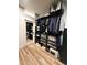Large walk-in closet with shelving, racks, and storage with a sliding mirror door at 653 Glenarbor Cir, Longmont, CO 80504